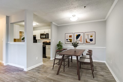 a dining room with a table and chairs and a kitchen